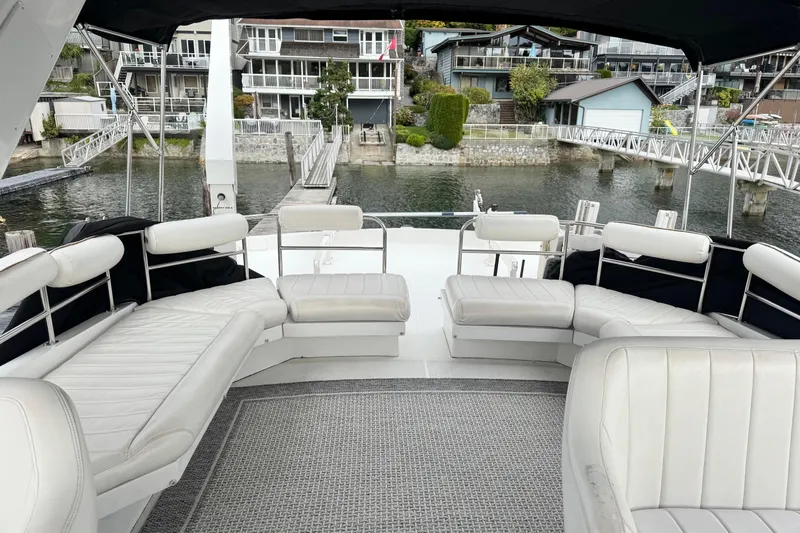  Yacht Photos Pics Luxurious seating area on a 2001 Navigator 56 Classic Pilothouse yacht, docked by waterfront homes.