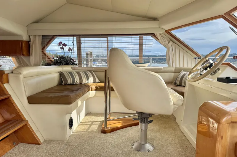  Yacht Photos Pics Luxurious 2001 Navigator 56 Classic Pilothouse interior with plush seating and panoramic windows.