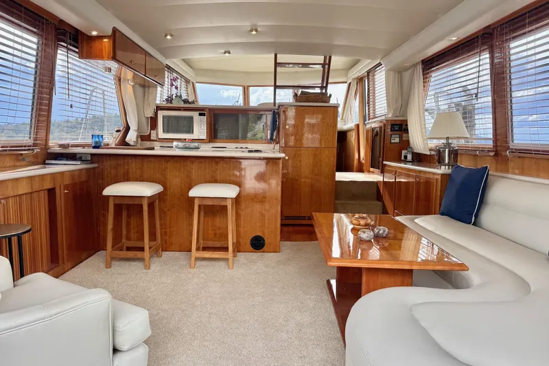  Yacht Photos Pics Luxurious interior of 2001 Navigator 56 Classic Pilothouse yacht with elegant wood finishes.