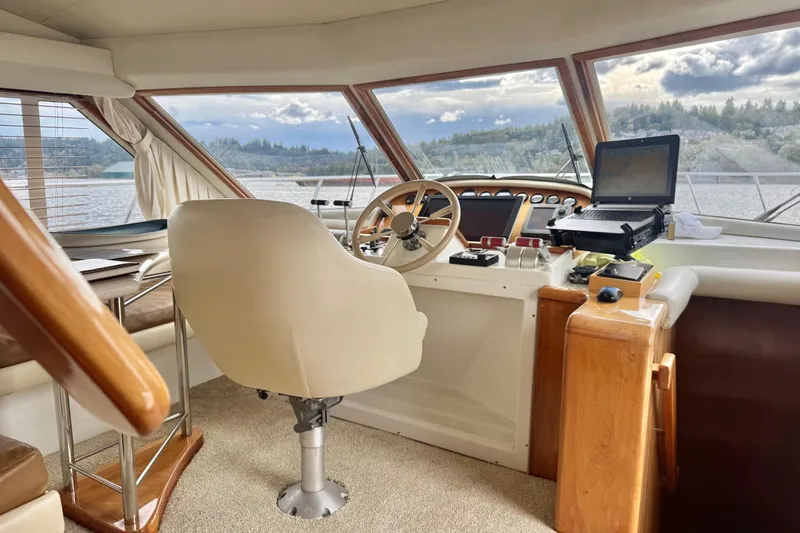  Yacht Photos Pics Pilothouse interior of 2001 Navigator 56 Classic yacht with steering wheel and navigation equipment.