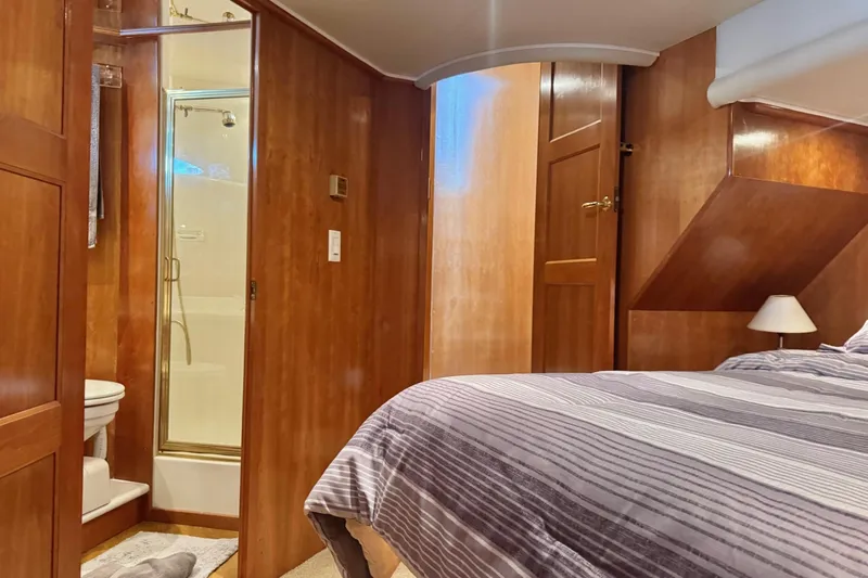  Yacht Photos Pics Interior of 2001 Navigator 56 Classic Pilothouse with wood paneling and ensuite bathroom.