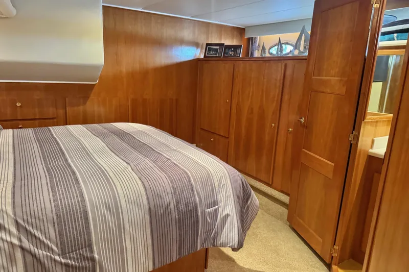  Yacht Photos Pics Luxurious wood-paneled bedroom in 2001 Navigator 56 Classic Pilothouse yacht.