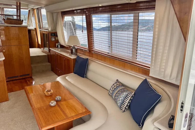  Yacht Photos Pics Luxurious interior of 2001 Navigator 56 Classic Pilothouse yacht with elegant wood finishes.
