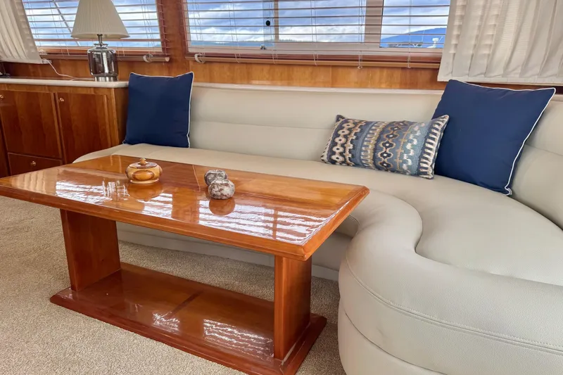  Yacht Photos Pics Luxurious interior of 2001 Navigator 56 Classic Pilothouse with elegant sofa and wooden table.