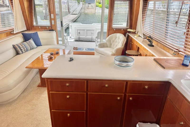  Yacht Photos Pics Luxurious interior of 2001 Navigator 56 Classic Pilothouse yacht with elegant wood finishes.
