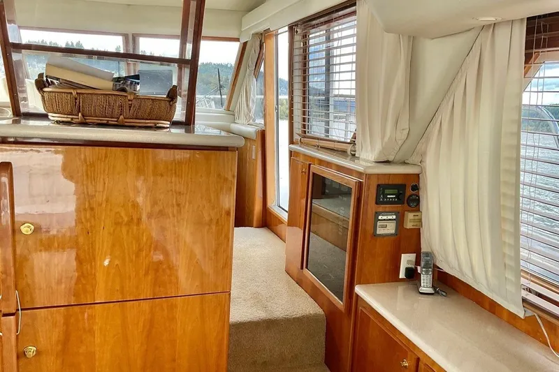  Yacht Photos Pics Interior of 2001 Navigator 56 Classic Pilothouse with wood finish and nautical decor.