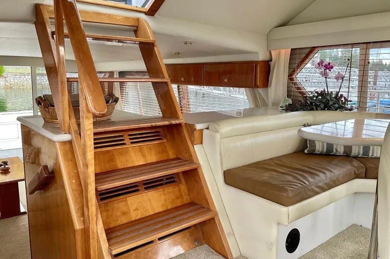  Yacht Photos Pics Interior of 2001 Navigator 56 Classic Pilothouse with wooden stairs and cozy seating area.