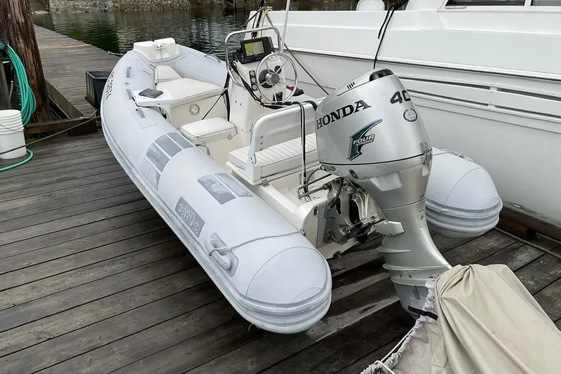  Yacht Photos Pics Inflatable boat with Honda 40 outboard motor docked beside Navigator 56 Classic Pilothouse.