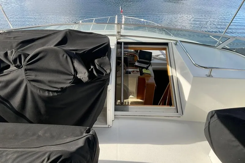  Yacht Photos Pics 2001 Navigator 56 Classic Pilothouse yacht interior with covered seating and helm view.