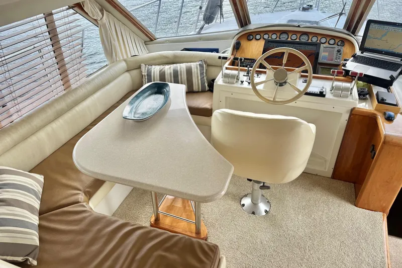  Yacht Photos Pics Luxurious 2001 Navigator 56 Classic Pilothouse interior with helm, seating, and navigation equipment.