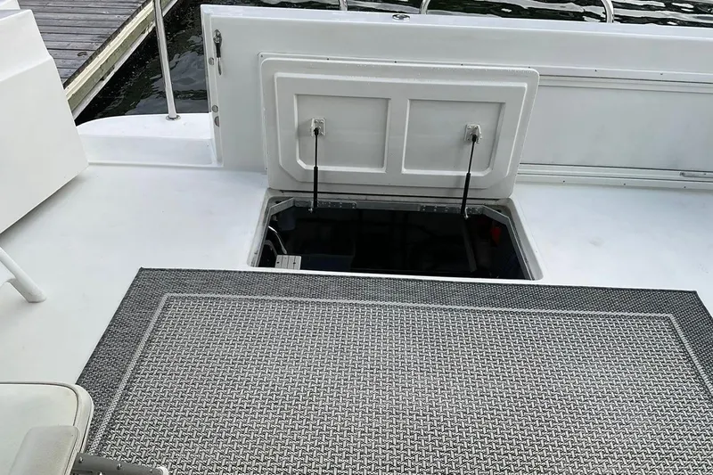  Yacht Photos Pics Open hatch on 2001 Navigator 56 Classic Pilothouse boat deck, revealing storage compartment.