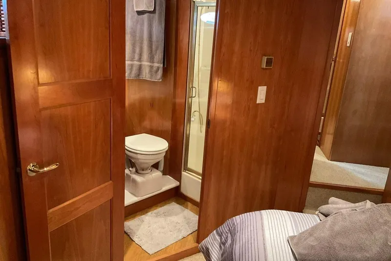  Yacht Photos Pics Interior of 2001 Navigator 56 Classic Pilothouse yacht bathroom with wooden finish.
