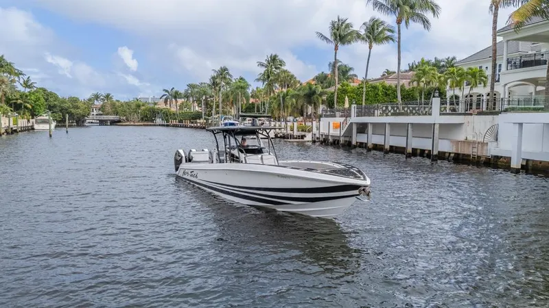 Yacht Photos Pics 2024 Nor-Tech 392 Super Fish boat cruising on a scenic waterway with palm trees.