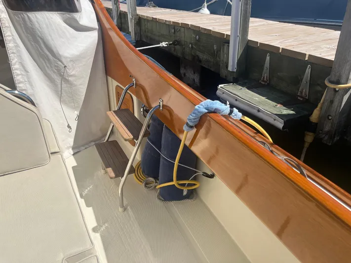  Yacht Photos Pics Hinckley Picnic 1999 boat interior with wooden trim and dock view.