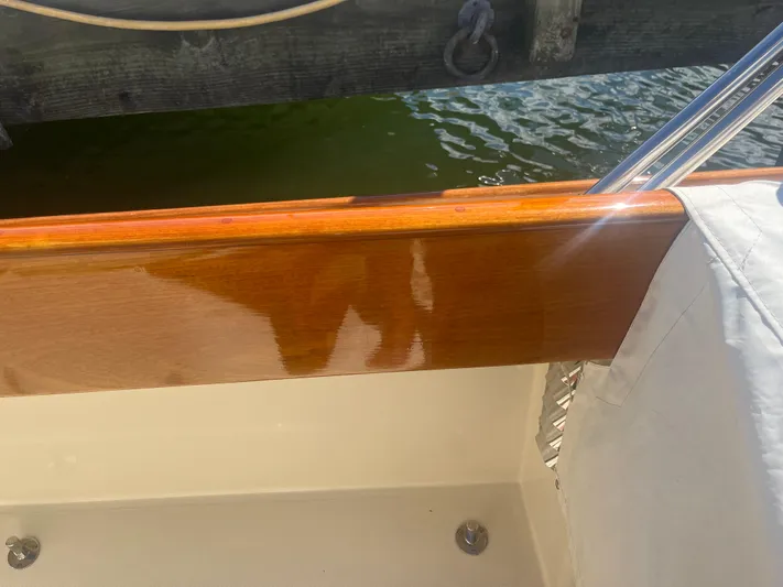  Yacht Photos Pics Polished wood detail on a 1999 Hinckley Picnic boat by the water.