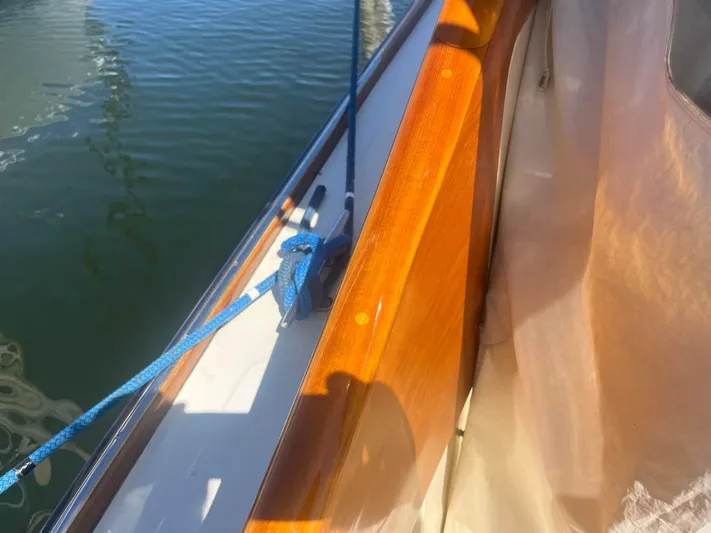  Yacht Photos Pics 1999 Hinckley Picnic boat with polished wood and blue rope detail.