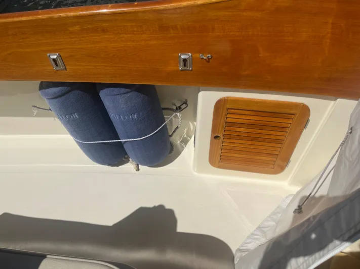  Yacht Photos Pics 1999 Hinckley Picnic boat interior with wooden paneling and blue fenders.