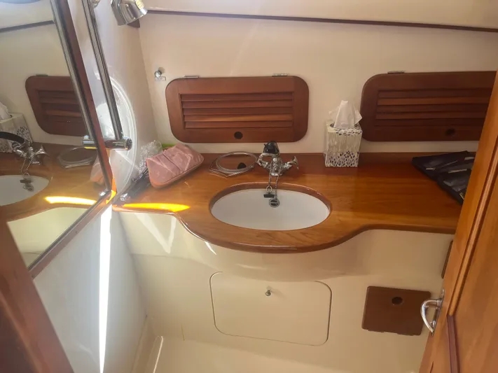  Yacht Photos Pics 1999 Hinckley Picnic boat interior with wooden vanity and sink.