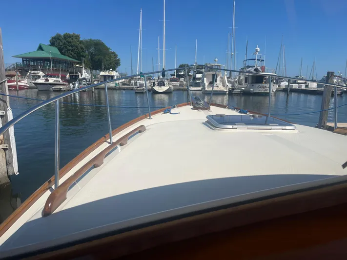  Yacht Photos Pics Hinckley Picnic boat from 1999 docked in a marina with clear blue skies.