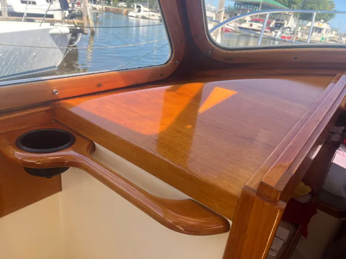  Yacht Photos Pics Interior of a 1999 Hinckley Picnic boat with polished wood and cup holder.