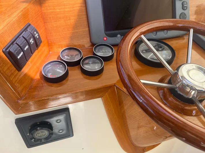  Yacht Photos Pics Hinckley Picnic 1999 boat dashboard with wooden steering wheel and gauges.
