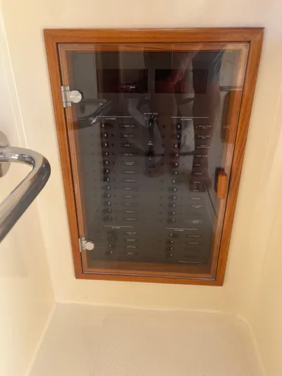  Yacht Photos Pics Electrical panel on a 1999 Hinckley Picnic boat, enclosed in a wooden frame.