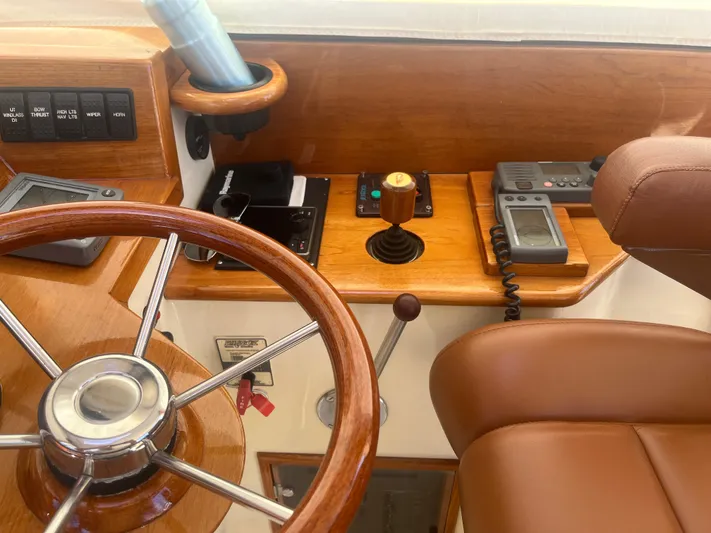  Yacht Photos Pics 1999 Hinckley Picnic boat helm with wooden steering wheel and navigation controls.
