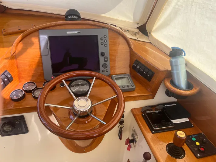  Yacht Photos Pics 1999 Hinckley Picnic boat helm with wooden steering wheel and navigation instruments.