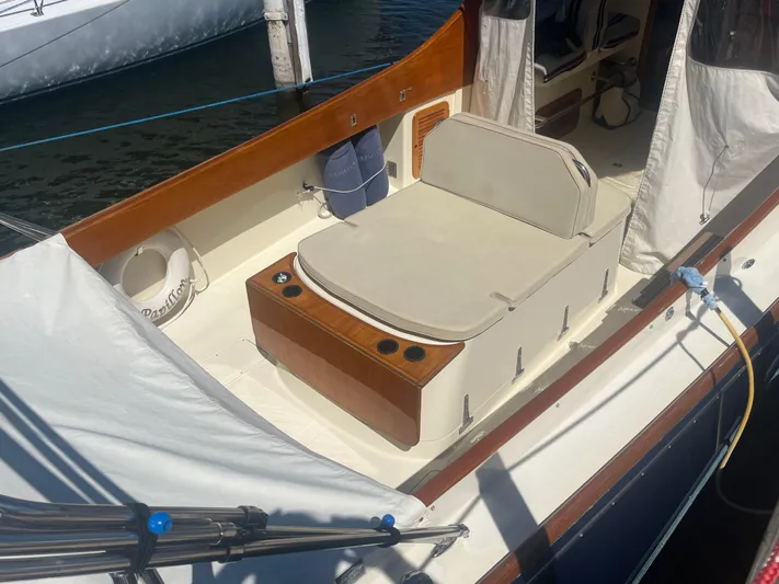  Yacht Photos Pics 1999 Hinckley Picnic boat interior with cushioned seating and wooden accents.