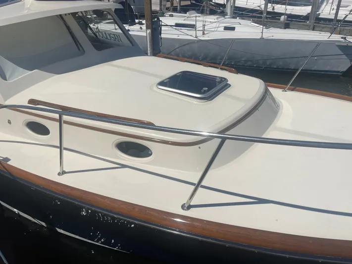  Yacht Photos Pics 1999 Hinckley Picnic boat with sleek deck and polished wood accents.