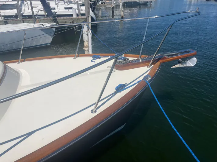  Yacht Photos Pics 1999 Hinckley Picnic boat docked, featuring sleek design and wooden accents.