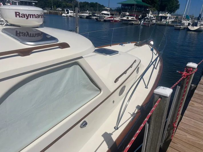  Yacht Photos Pics 1999 Hinckley Picnic boat docked at marina, featuring sleek design and Raymarine equipment.