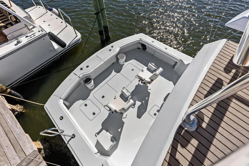 Bombshell Yacht Photos Pics 2003 Hatteras 65 Convertible yacht cockpit, docked, with fishing chairs and rod holders.
