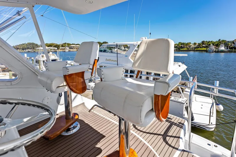 Bombshell Yacht Photos Pics Luxury seating on 2003 Hatteras 65 Convertible yacht, overlooking marina.