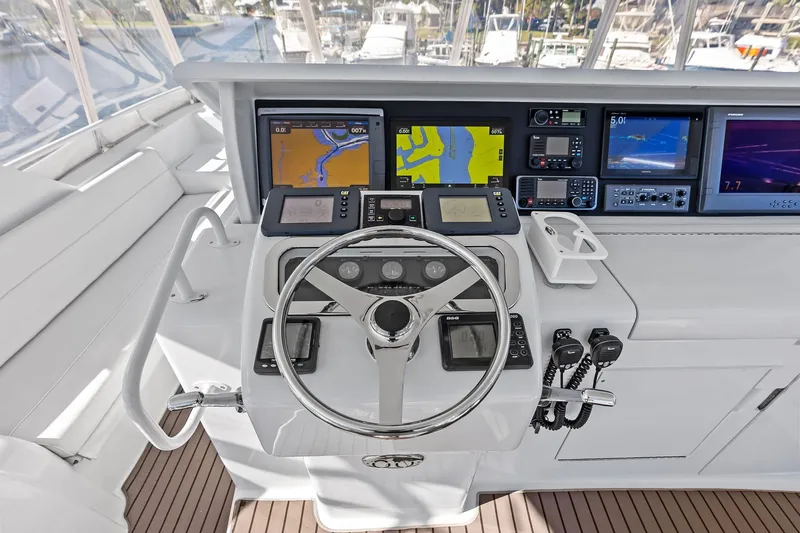 Bombshell Yacht Photos Pics Helm of 2003 Hatteras 65 Convertible yacht with navigation screens and controls.