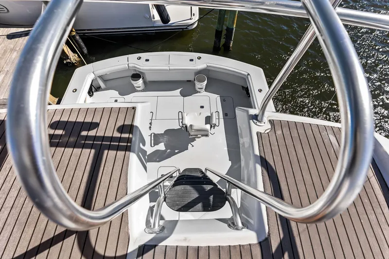 Bombshell Yacht Photos Pics 2003 Hatteras 65 Convertible yacht deck with stainless steel railings and water view.
