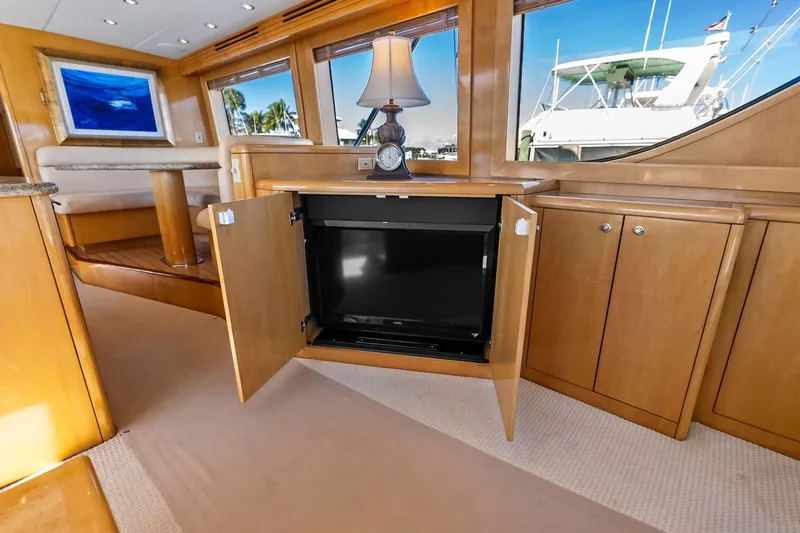 Bombshell Yacht Photos Pics Luxurious interior of 2003 Hatteras 65 Convertible yacht with hidden TV cabinet.