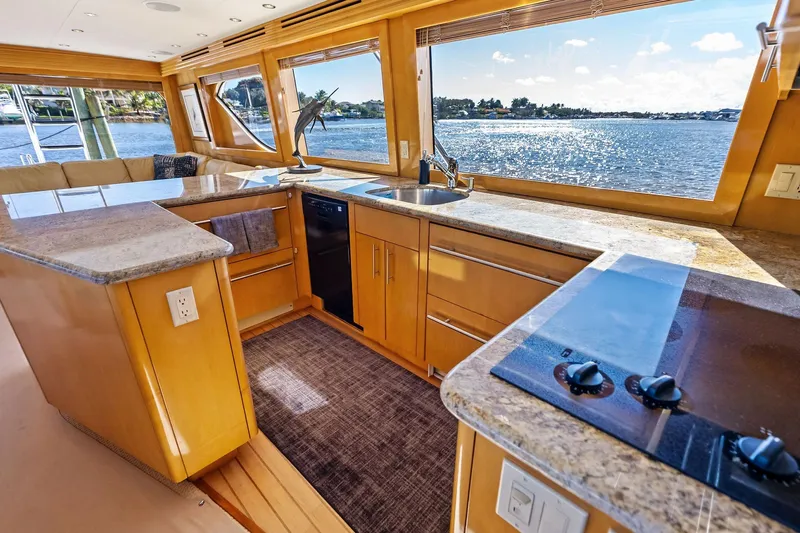 Bombshell Yacht Photos Pics Luxurious kitchen interior of 2003 Hatteras 65 Convertible yacht with ocean view.