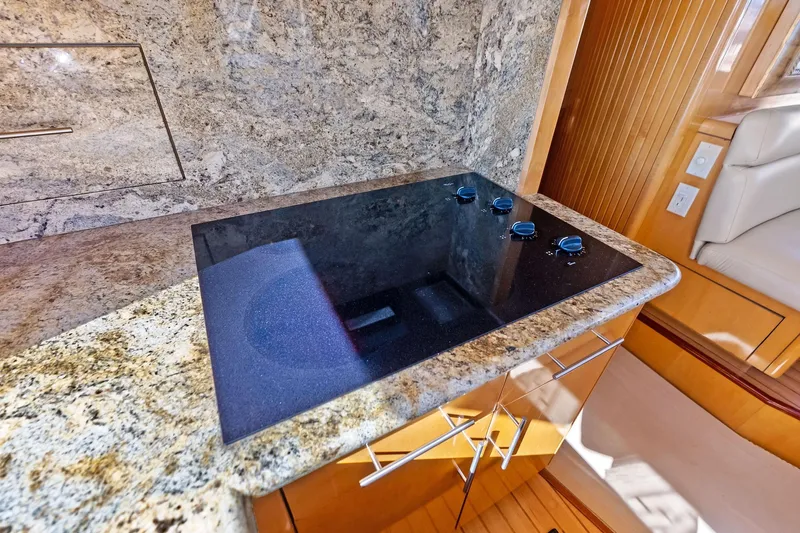 Bombshell Yacht Photos Pics Luxurious kitchen area on 2003 Hatteras 65 Convertible yacht with granite countertops.