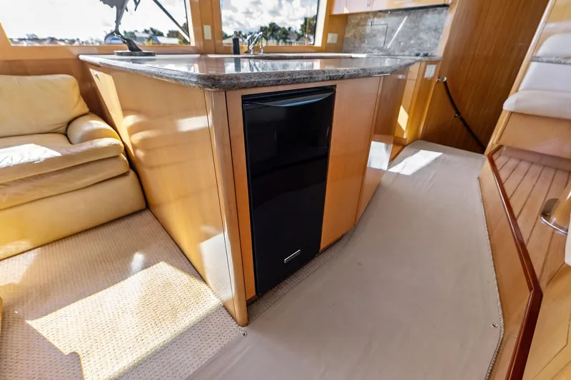 Bombshell Yacht Photos Pics Luxurious interior of 2003 Hatteras 65 Convertible yacht with modern kitchen amenities.