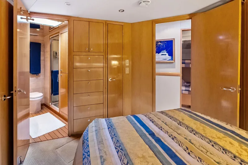 Bombshell Yacht Photos Pics Luxurious 2003 Hatteras 65 Convertible yacht interior with wood paneling and ensuite bathroom.