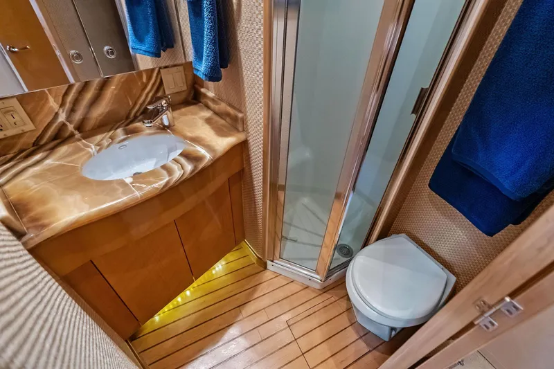 Bombshell Yacht Photos Pics Luxurious bathroom in 2003 Hatteras 65 Convertible yacht with marble sink and shower.