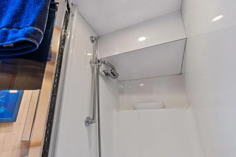 Bombshell Yacht Photos Pics Shower area in 2003 Hatteras 65 Convertible yacht with modern fixtures.
