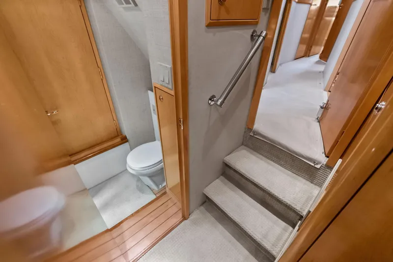 Bombshell Yacht Photos Pics Interior of 2003 Hatteras 65 Convertible yacht, featuring stairs and a compact bathroom.