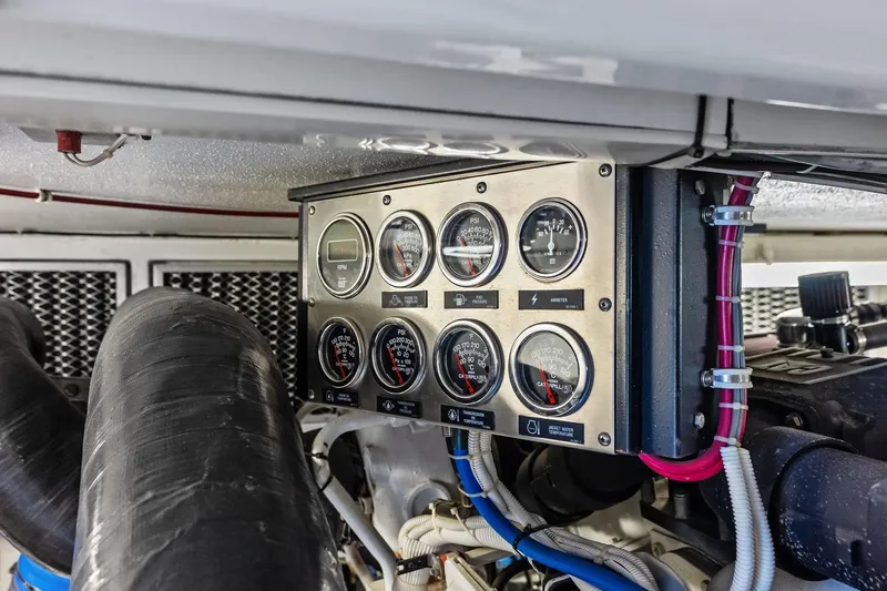 Bombshell Yacht Photos Pics Engine control panel of a 2003 Hatteras 65 Convertible yacht, featuring gauges and wiring.