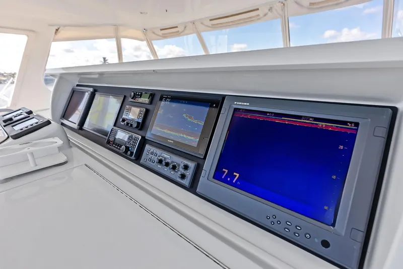 Bombshell Yacht Photos Pics Control panel of 2003 Hatteras 65 Convertible yacht with navigation screens and instruments.