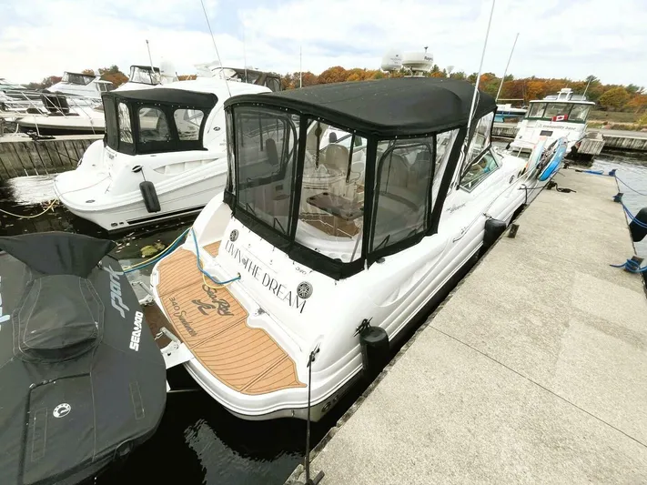  Yacht Photos Pics 2005 Sea Ray 340 Sundancer docked at marina with black canopy.