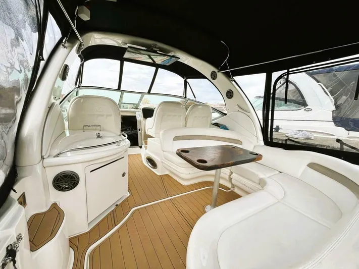  Yacht Photos Pics 2005 Sea Ray 340 Sundancer interior with white seating and wooden flooring.
