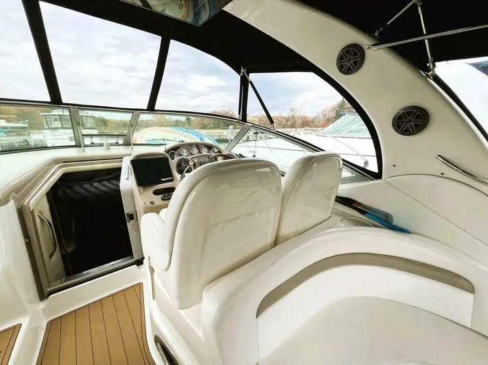  Yacht Photos Pics 2005 Sea Ray 340 Sundancer cockpit with white seating and modern dashboard.