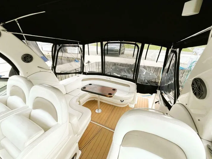 Yacht Photos Pics 2005 Sea Ray 340 Sundancer interior with white seating and wooden table.